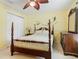 Bedroom has ceiling fan, double closet, and dark wooden furniture at 2493 Pine Chase Cir, St Cloud, FL 34769