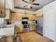 Bright kitchen with stainless steel appliances, wooden cabinets, and tile backsplash at 2493 Pine Chase Cir, St Cloud, FL 34769