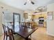 Eat-in kitchen features wood floors, stainless steel appliances, and a large dining table at 2493 Pine Chase Cir, St Cloud, FL 34769