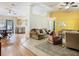 Open-concept living room showcasing tile floors, a view of kitchen, and an inviting sitting area at 2493 Pine Chase Cir, St Cloud, FL 34769