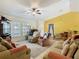 Spacious living room with comfortable seating, neutral carpet, and bright natural light at 2493 Pine Chase Cir, St Cloud, FL 34769