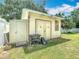 Outdoor storage shed featuring double doors, side door, and workbench and offering ample storage space at 2493 Pine Chase Cir, St Cloud, FL 34769