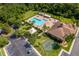 Aerial view of community pool, clubhouse, playground, and parking, surrounded by lush landscaping at 2736 Atherton Dr, Orlando, FL 32824
