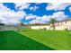 Expansive backyard with lush green grass, complemented by an outdoor dining set and privacy fence at 2736 Atherton Dr, Orlando, FL 32824