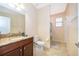 Bathroom featuring granite countertop, wood cabinetry, and a walk-in shower at 2736 Atherton Dr, Orlando, FL 32824