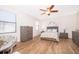 Cozy bedroom with a ceiling fan, wood flooring, and natural light from the windows with privacy blinds at 2736 Atherton Dr, Orlando, FL 32824