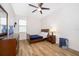 Cozy bedroom with wooden floors, a wooden dresser, a window and neutral walls at 2736 Atherton Dr, Orlando, FL 32824