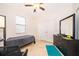 Well-lit bedroom features a ceiling fan, neutral walls, tile flooring, and double door closet at 2736 Atherton Dr, Orlando, FL 32824
