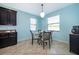 Bright breakfast nook features light blue walls, a pendant light, and views to the landscaped backyard at 2736 Atherton Dr, Orlando, FL 32824