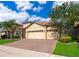 Inviting single-story home with a brick driveway, a well-kept lawn, and mature tree at 2736 Atherton Dr, Orlando, FL 32824
