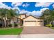 Charming single-story home with brick driveway, manicured lawn, and lush landscaping at 2736 Atherton Dr, Orlando, FL 32824