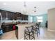Charming kitchen featuring dark cabinets, granite countertops, stainless steel appliances, and breakfast bar seating at 2736 Atherton Dr, Orlando, FL 32824