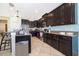 Spacious kitchen featuring stainless appliances, dark cabinetry, breakfast bar, and easy access to living areas at 2736 Atherton Dr, Orlando, FL 32824