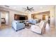 Bright living room with modern fan, light blue sofas, and a large television mounted on a stained wood wall at 2736 Atherton Dr, Orlando, FL 32824