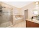 Bright main bathroom featuring a walk-in shower, soaking tub, and double sink vanity with granite counters at 2736 Atherton Dr, Orlando, FL 32824