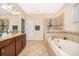 Well-lit main bathroom with walk-in shower, soaking tub, and double sink vanity with plenty of counter space at 2736 Atherton Dr, Orlando, FL 32824