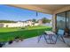 Relaxing covered patio featuring an outdoor dining set overlooking the well-maintained backyard at 2736 Atherton Dr, Orlando, FL 32824