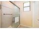 Walk-in shower with clear glass door and tile surround, and a window for natural light at 2736 Atherton Dr, Orlando, FL 32824