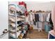 Walk-in closet with shelving and racks for shoes and clothes, plus a stool for convenience at 2736 Atherton Dr, Orlando, FL 32824