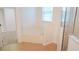 Bright bathroom with a soaking tub and glass-enclosed shower at 2750 Eagle Lake Dr, Clermont, FL 34711