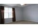 Cozy bedroom featuring a ceiling fan, carpet, and window with stylish brown curtains at 2750 Eagle Lake Dr, Clermont, FL 34711