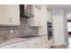Contemporary kitchen featuring stainless steel appliances, granite counters, tile backsplash, and plenty of cabinet storage at 2750 Eagle Lake Dr, Clermont, FL 34711
