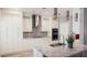 Modern kitchen with stainless steel appliances, granite countertops, tile backsplash, and ample cabinet space at 2750 Eagle Lake Dr, Clermont, FL 34711