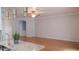Spacious open floor plan of the living room featuring a kitchen bar and hardwood floors at 2750 Eagle Lake Dr, Clermont, FL 34711