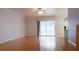 Open-concept living room with hardwood floors, ceiling fan, and sliding glass doors leading to an outdoor area at 2750 Eagle Lake Dr, Clermont, FL 34711
