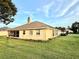 Home exterior features a screened porch and backyard with lush lawn at 3 Sunrise Dr, Ocala, FL 34472