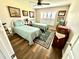 Cozy bedroom featuring twin beds, shuttered windows, and wood-look flooring at 3 Sunrise Dr, Ocala, FL 34472