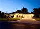 Charming single-story home with well-manicured lawn and inviting front entrance at twilight at 3 Sunrise Dr, Ocala, FL 34472