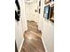 Hallway featuring wood flooring and multiple doors, offering access to different rooms in the home at 3 Sunrise Dr, Ocala, FL 34472