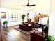 View of a living room showcasing plantation shutters, dark wood floors, and traditional decor at 3 Sunrise Dr, Ocala, FL 34472