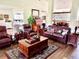 Inviting living room featuring leather furniture, hardwood floors, and ample seating at 3 Sunrise Dr, Ocala, FL 34472
