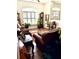 Inviting living room highlighting dark wood floors, plantation shutters, and traditional décor at 3 Sunrise Dr, Ocala, FL 34472