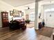 Open-concept living room boasting dark wood floors, a ceiling fan, and a front entrance at 3 Sunrise Dr, Ocala, FL 34472