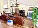 Comfortable living room featuring a fireplace, ceiling fan, and vaulted ceilings at 3 Sunrise Dr, Ocala, FL 34472