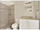 Bathroom with tiled shower, vanity with sink, toilet and modern lighting at 3 Trophy Ln, Kissimmee, FL 34759