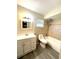 Bathroom featuring a shower-tub combination with tiled walls and an integrated white sink vanity at 3 Trophy Ln, Kissimmee, FL 34759