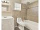 Bathroom with shower over bath, window, tile backsplash, vanity, and modern toilet at 3 Trophy Ln, Kissimmee, FL 34759