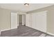 Bedroom with wood-look floors, closet, and access to bathroom and hallway at 3 Trophy Ln, Kissimmee, FL 34759