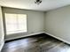 Bright bedroom with hardwood floors and neutral paint, illuminated by natural light from the window at 3 Trophy Ln, Kissimmee, FL 34759