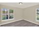 Bedroom featuring laminate floors, two windows, and neutral color at 3 Trophy Ln, Kissimmee, FL 34759