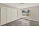 Bedroom with wood-look floors, closet, and a window with a view to the outside at 3 Trophy Ln, Kissimmee, FL 34759