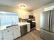 Updated kitchen featuring stainless steel appliances, white cabinets, and a stylish backsplash at 3 Trophy Ln, Kissimmee, FL 34759