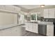 Clean kitchen features white cabinets, stainless steel appliances, and modern gray wood flooring at 3 Trophy Ln, Kissimmee, FL 34759