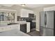 Bright kitchen with stainless steel appliances, granite countertops, and gray wood flooring at 3 Trophy Ln, Kissimmee, FL 34759