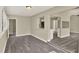 Open living space featuring hardwood flooring and seamless transitions to other areas of the home at 3 Trophy Ln, Kissimmee, FL 34759