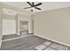Bright living room featuring modern gray wood flooring, neutral walls, and a ceiling fan at 3 Trophy Ln, Kissimmee, FL 34759